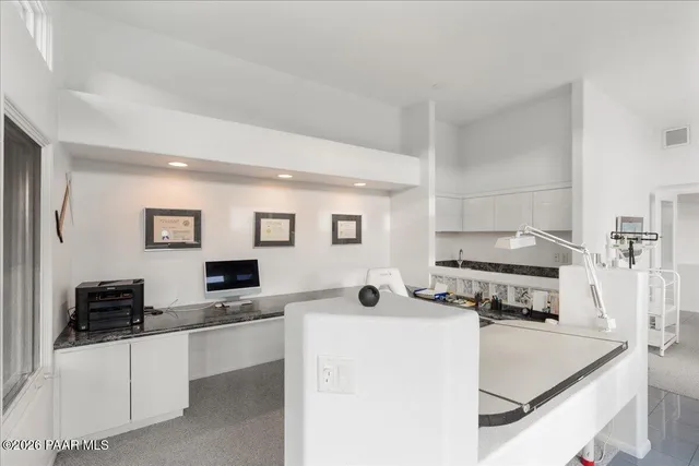 a kitchen with stainless steel appliances a stove top oven a sink a counter top space and cabinets