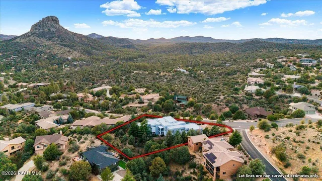 an aerial view of residential houses with outdoor space and street view