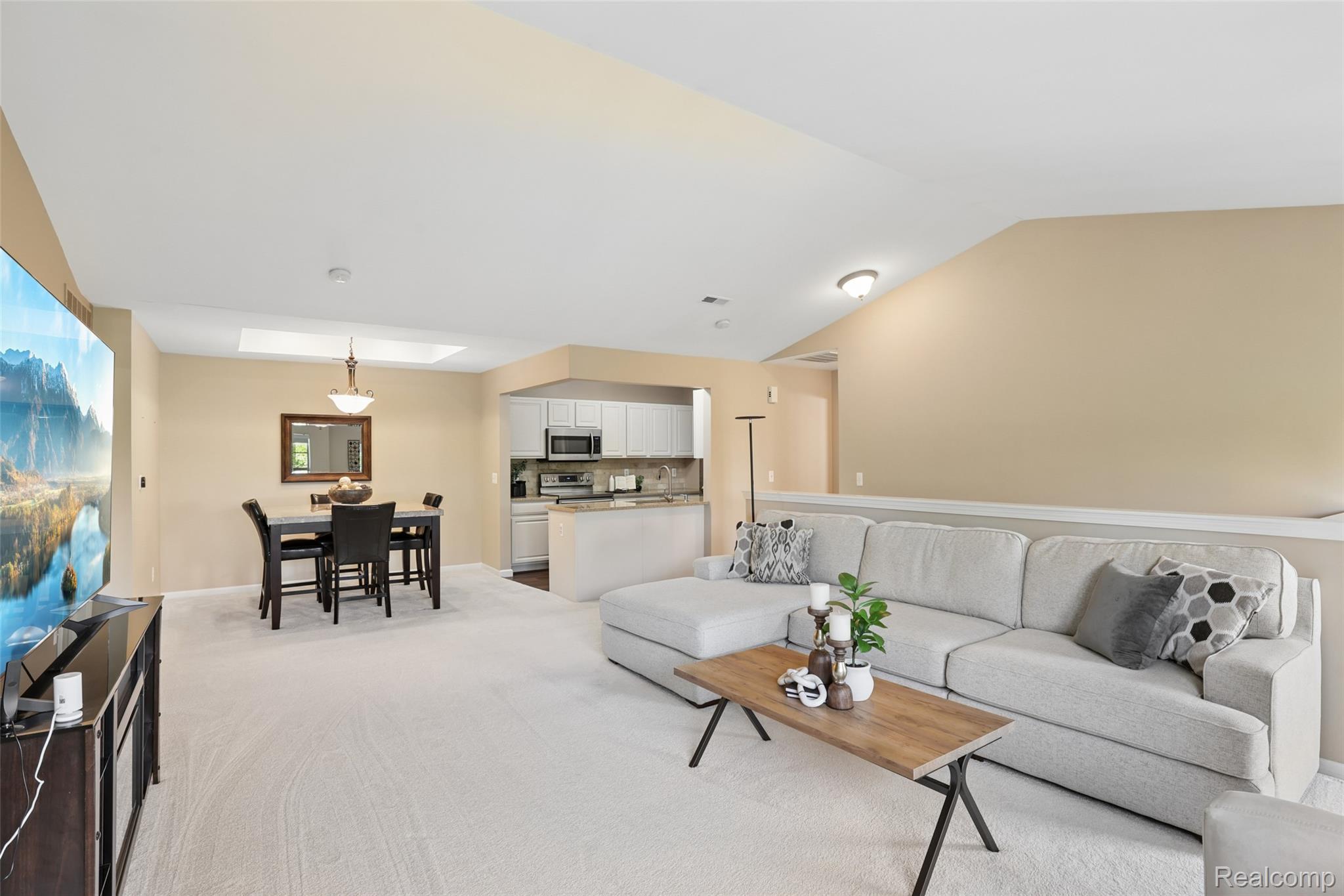 11862 Farmington Road Livonia, MI 48150 - Photo 19 of 29 Carpeted living area featuring a vaulted ceiling and a skylight