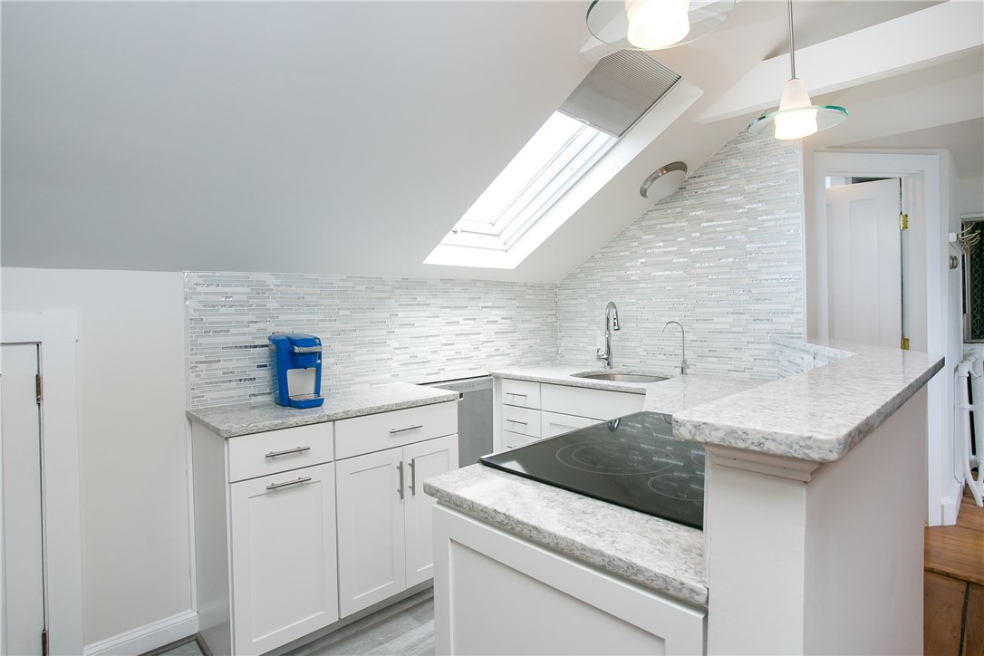 42 Kay Street, Unit 5 Newport, RI 02840 - Photo 16 of 34 Glass tile back splash, quartz counter tops, new cabinets, draw pulls sink, faucet, appliances.
The dishwasher is recessed into the storage space to allow for more room.