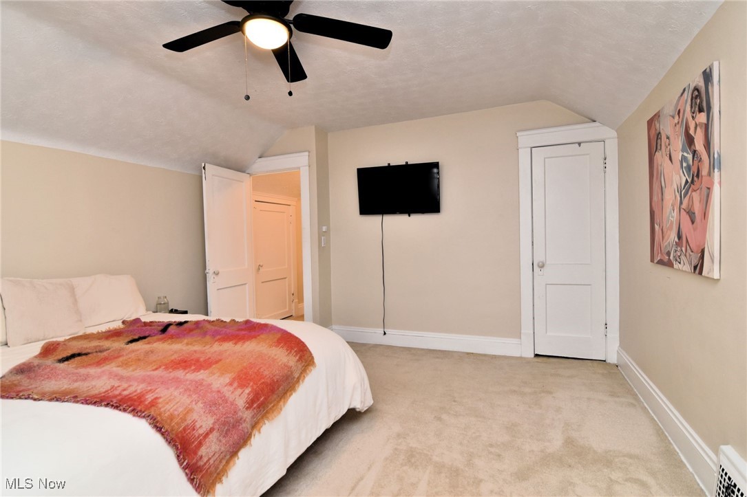 13048 Cedar Road Cleveland, OH 44118 - Photo 22 of 40 Bedroom with a textured ceiling, vaulted ceiling, light carpet, and ceiling fan- 2nd floor