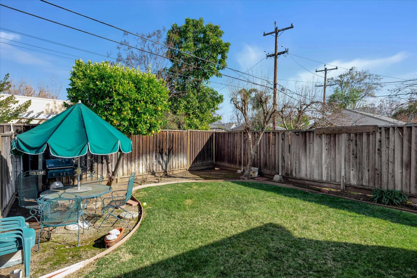 1944 Bird Avenue San Jose, CA 95125 - Photo 15 of 15 a view of a backyard with chairs under an umbrella
