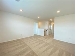 213 Saide Street Georgetown, TX 78626 - Photo 19 of 32 Spacious room featuring neutral carpeting with a patterned design, recessed lighting, and light-colored walls