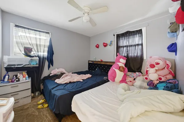 a bedroom with two beds and a dresser