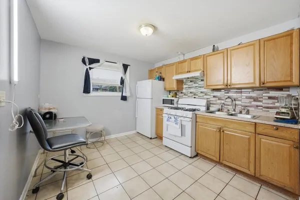 a kitchen with sink cabinets and window