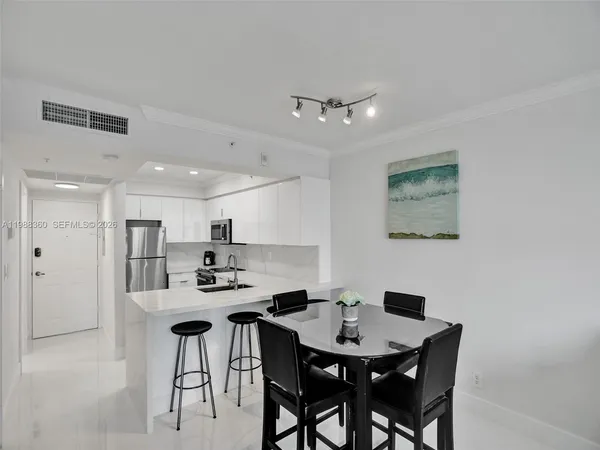 a bathroom with a granite countertop sink mirror and a toilet