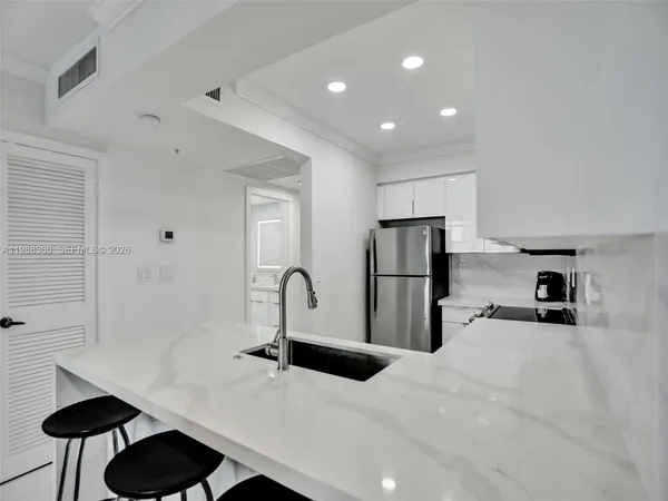 a kitchen with cabinets and stainless steel appliances