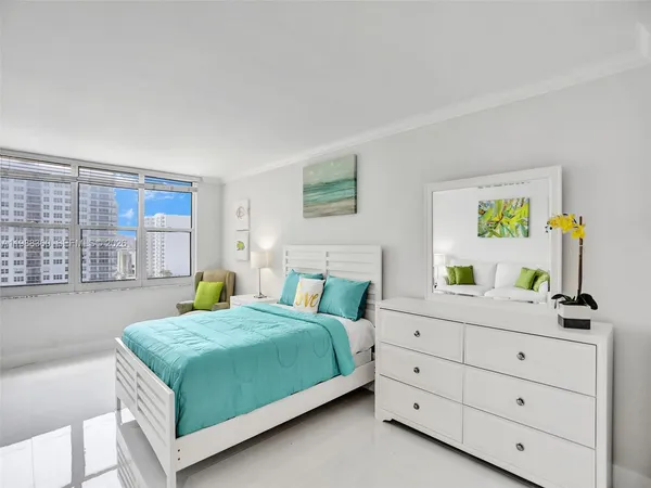 a bedroom with a bed a table and chair