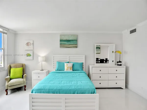 a kitchen with kitchen island a dining table and chairs