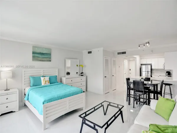 a kitchen with a refrigerator a stove a sink dishwasher and white cabinets with wooden floor