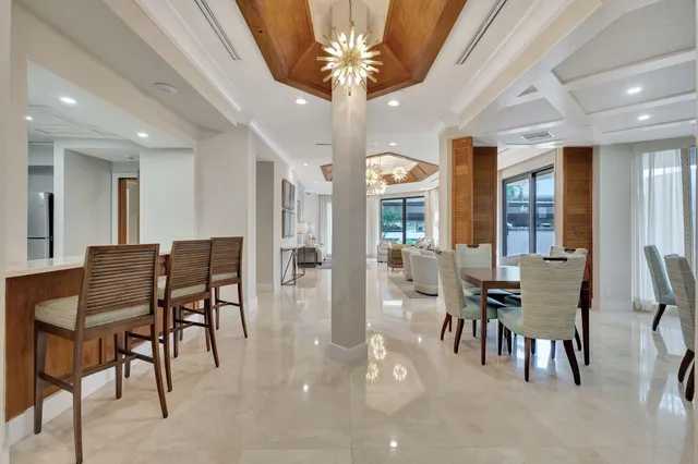 a front view of a building with a garden and trees