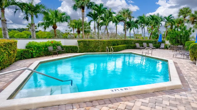 an aerial view of a house with a garden and swimming pool