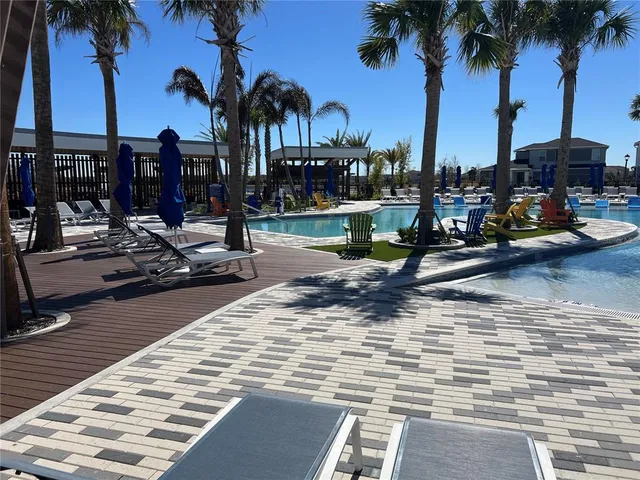 a view of a lake with a table and chairs