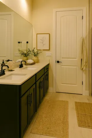 a bathroom with a double vanity sink and a mirror