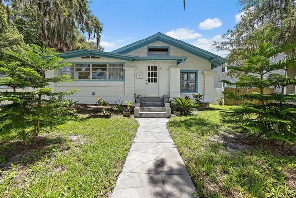 a front view of house with yard and green space
