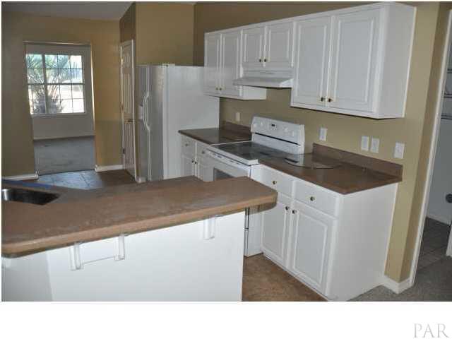 7147 Jennifer Road Pensacola, FL 32526 - Photo 7 of 11 Breakfast bar and granite countertops in kitchen: 7147 Jennifer Rd Pensacola FL