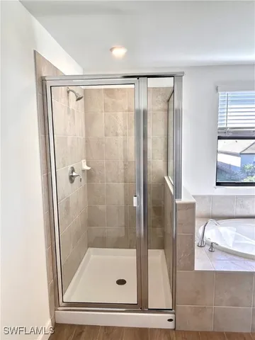 a bathroom with a glass shower door
