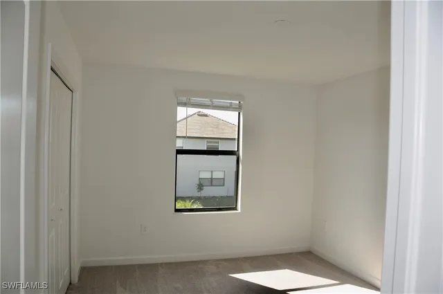 a view of an empty room and a window