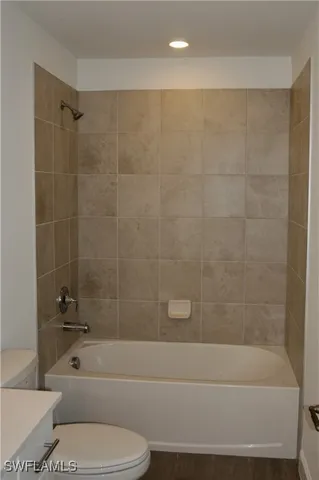 a bathroom with a bathtub toilet and shower