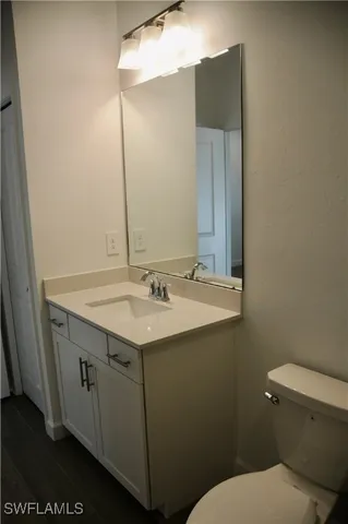 a bathroom with a sink and mirror with toilet