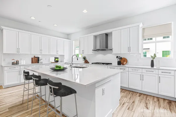 a kitchen with stainless steel appliances granite countertop a sink and cabinets