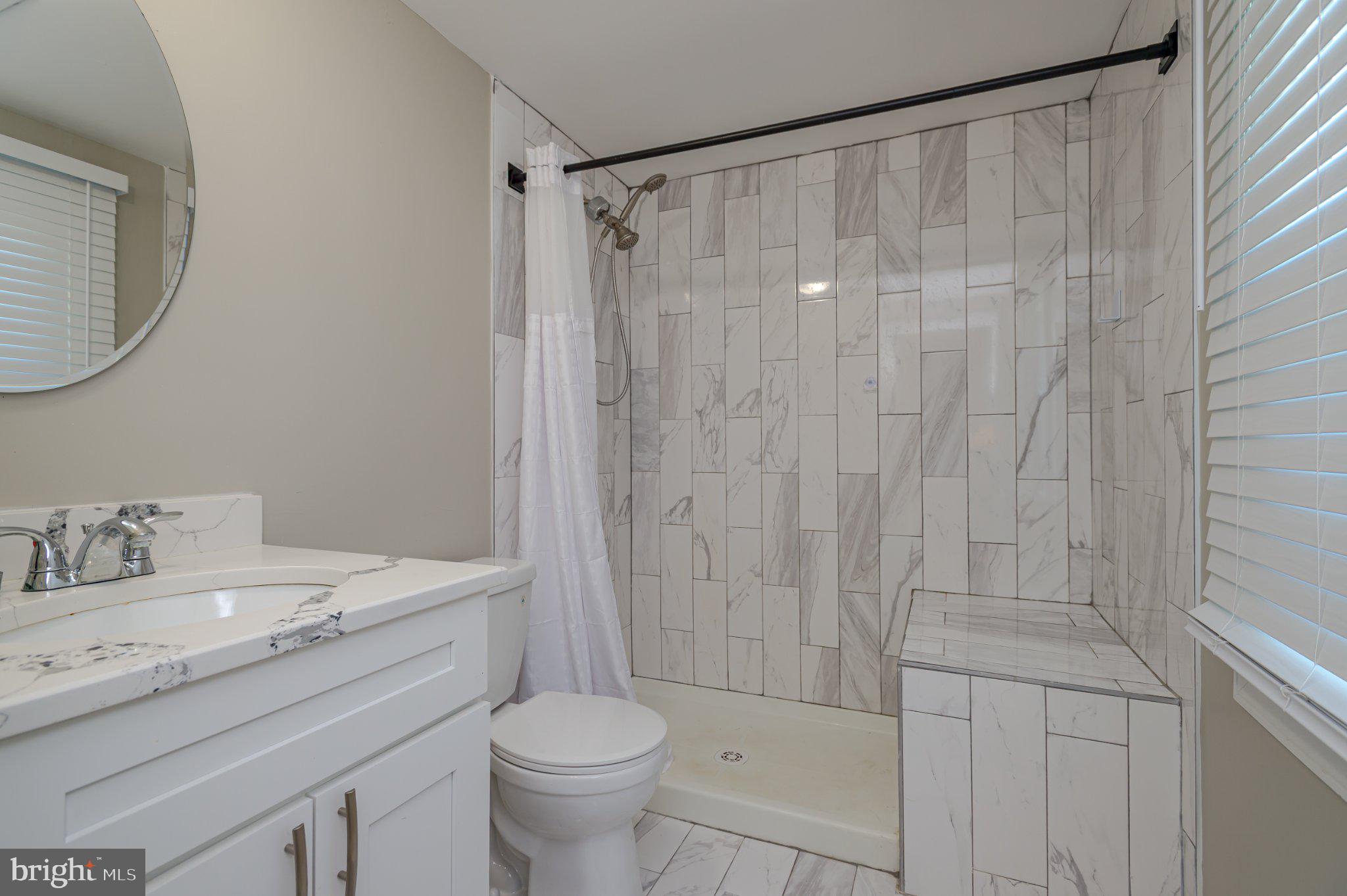 60 Midvale Lane Willingboro, NJ 08046 - Photo 18 of 24 a bathroom with a sink a toilet and a mirror