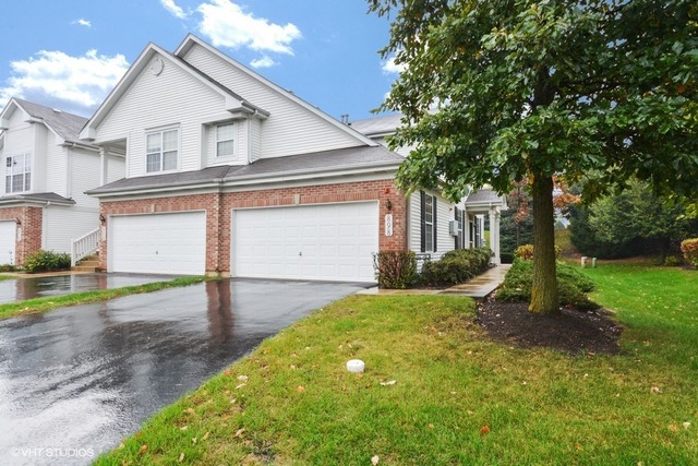 898 Riding Lane, Unit 898 St. Charles, IL 60174 - Photo 1 of 10 a view of a house with a yard and large tree