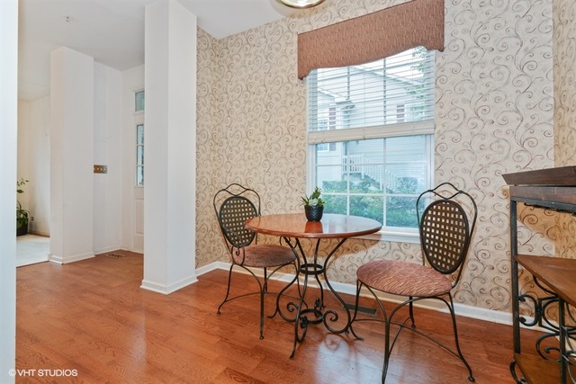 898 Riding Lane, Unit 898 St. Charles, IL 60174 - Photo 3 of 10 a view of a dining room with furniture and wooden floor