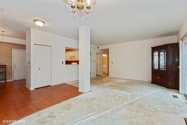 898 Riding Lane, Unit 898 St. Charles, IL 60174 - Photo 6 of 10 an empty room with fan and entrance