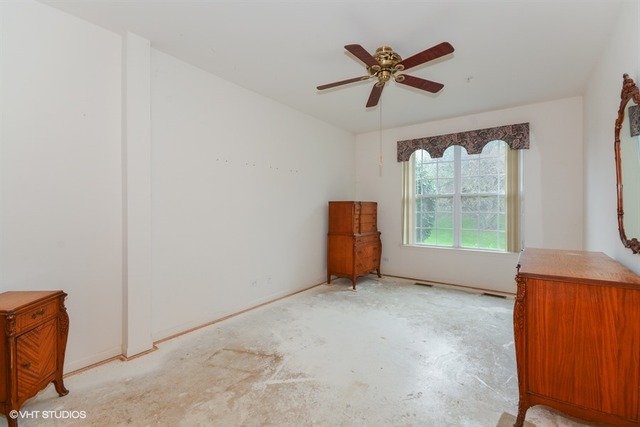 898 Riding Lane, Unit 898 St. Charles, IL 60174 - Photo 7 of 10 an empty room with windows and ceiling fan