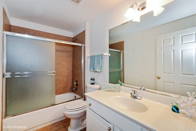 898 Riding Lane, Unit 898 St. Charles, IL 60174 - Photo 10 of 10 a bathroom with a sink a toilet and shower