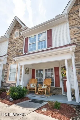 front view of a brick house with many windows