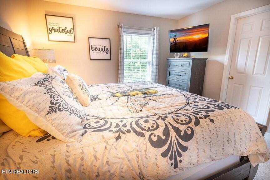 535 Orchard Valley Way Sevierville, TN 37862 - Photo 13 of 26 a bedroom with a bed and a flat screen tv