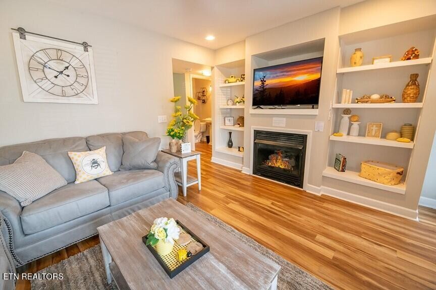 535 Orchard Valley Way Sevierville, TN 37862 - Photo 5 of 26 a living room with furniture a flat screen tv and a fireplace
