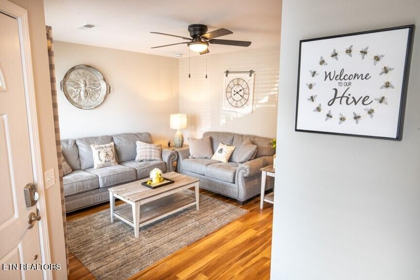 535 Orchard Valley Way Sevierville, TN 37862 - Photo 7 of 26 a living room with furniture and a wall painting