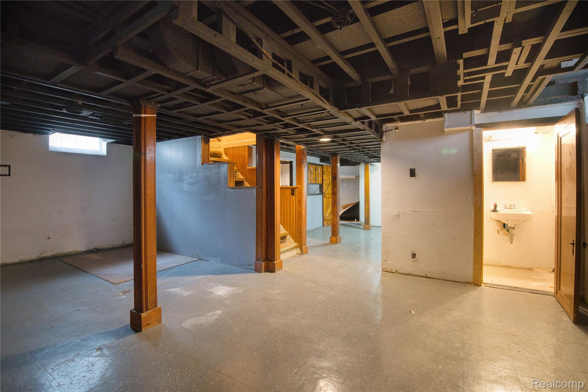 13644 Castleton Street Detroit, MI 48227 - Photo 15 of 18 Unfinished basement with exposed ceiling joists, concrete flooring, and a utility sink