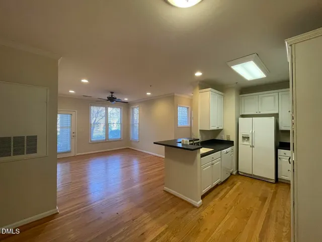 a kitchen with granite countertop a stove and a refrigerator