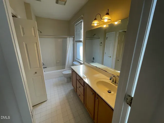 a bathroom with a double vanity sink and mirror with shower