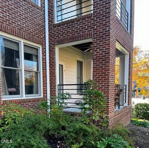 a view of a brick house with a large windows and large windows