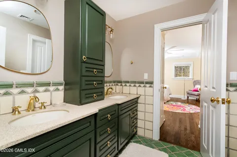 a bathroom with a sink double vanity and a mirror