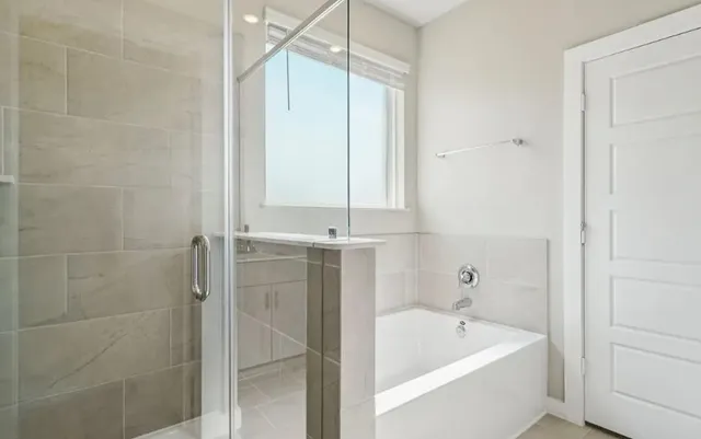 a bathroom with a tub a sink and a shower