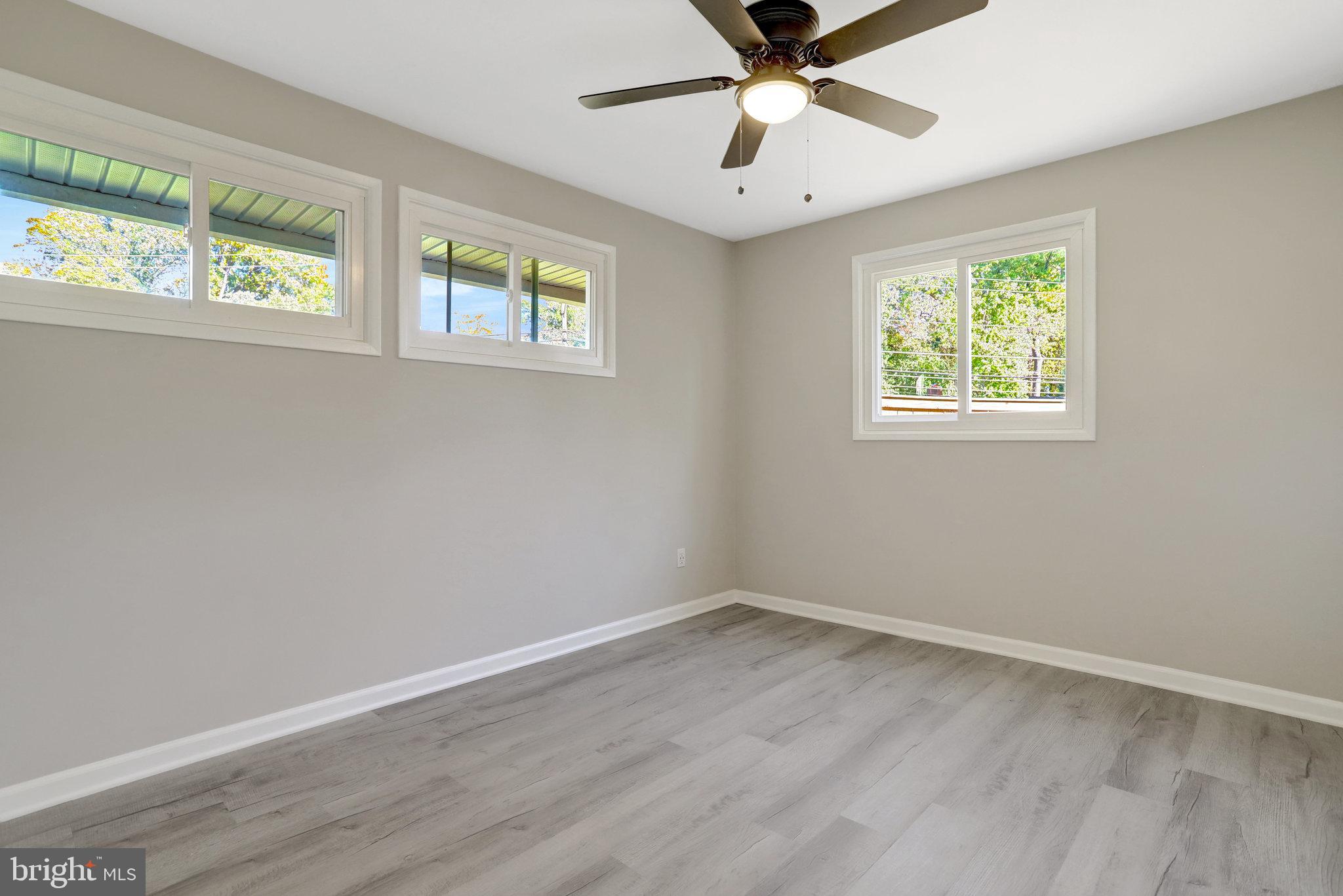 5301 Ferndale Street Springfield, VA 22151 - Photo 23 of 32 a view of an empty room with wooden floor and a window