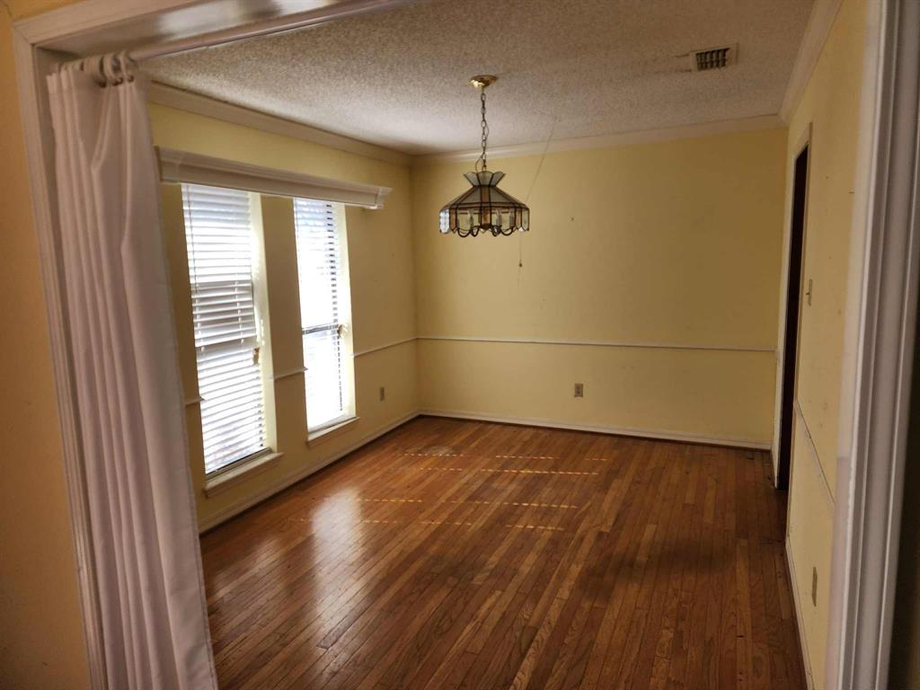 1316 Edna Street Commerce, TX 75428 - Photo 11 of 16 a view of a room with wooden floor and a window