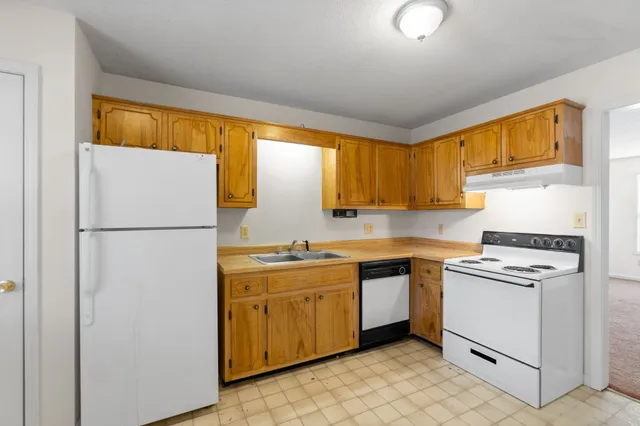 a kitchen with appliances cabinets and a sink
