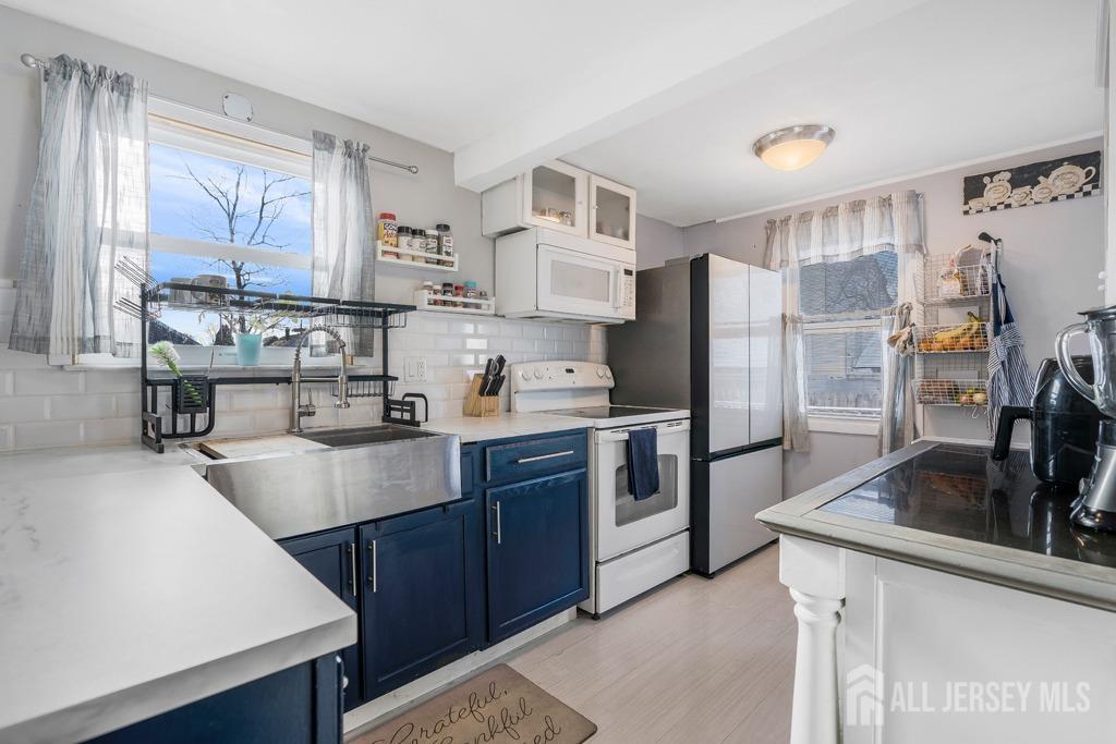 14 Grandview Street Middlesex, NJ 08846 - Photo 13 of 28 a kitchen with stainless steel appliances a sink a stove a refrigerator and cabinets