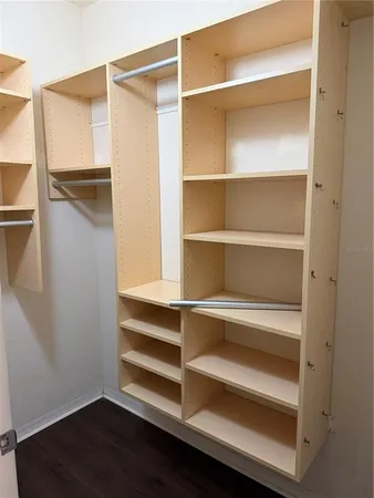 a view of walk in closet with empty racks