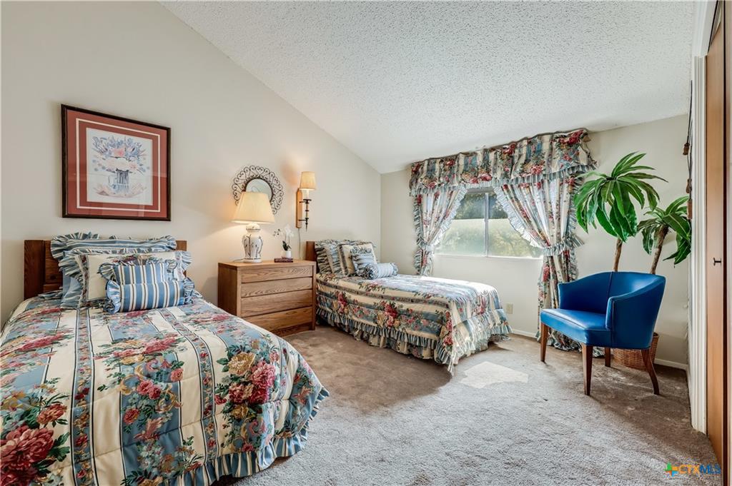133 Comanche Drive Point Venture, TX 78645 - Photo 22 of 32 a bedroom with bed and a potted plant