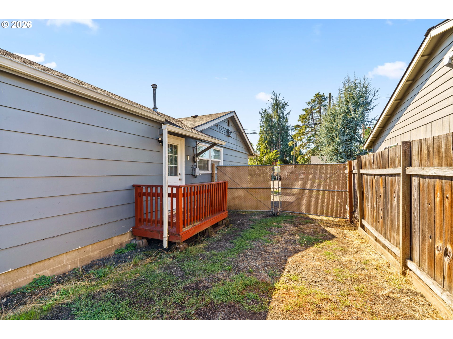 830 South 7th Street Cottage Grove, OR 97424 - Photo 20 of 33 a view of a backyard with white fence and wooden fence