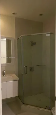 a bathroom with a shower and a sink