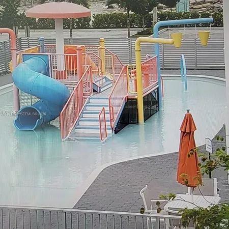 swimming pool view with a seating space